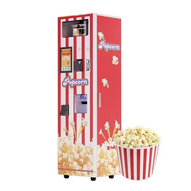 Red and white popcorn vending machine with a bowl of popcorn in front.